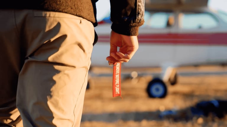 Person holding a measuring tape on a construction site with tools and equipment in the background